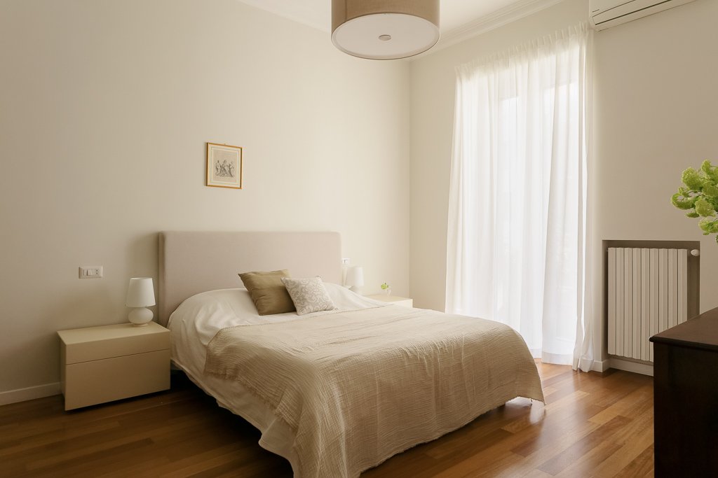 Bedroom 1 before bed reset — original messy bedding